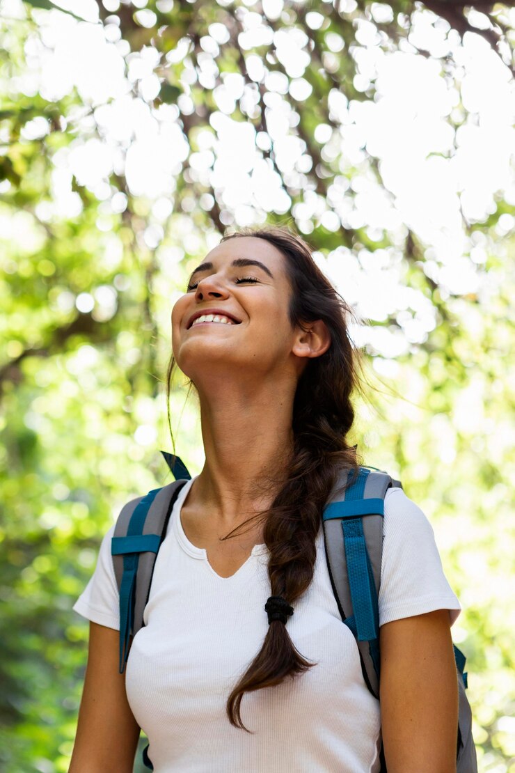smiley woman exploring nature with backpack 23 2148647947
